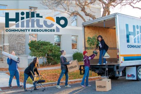 People loading up office supplies and furniture into a moving truck