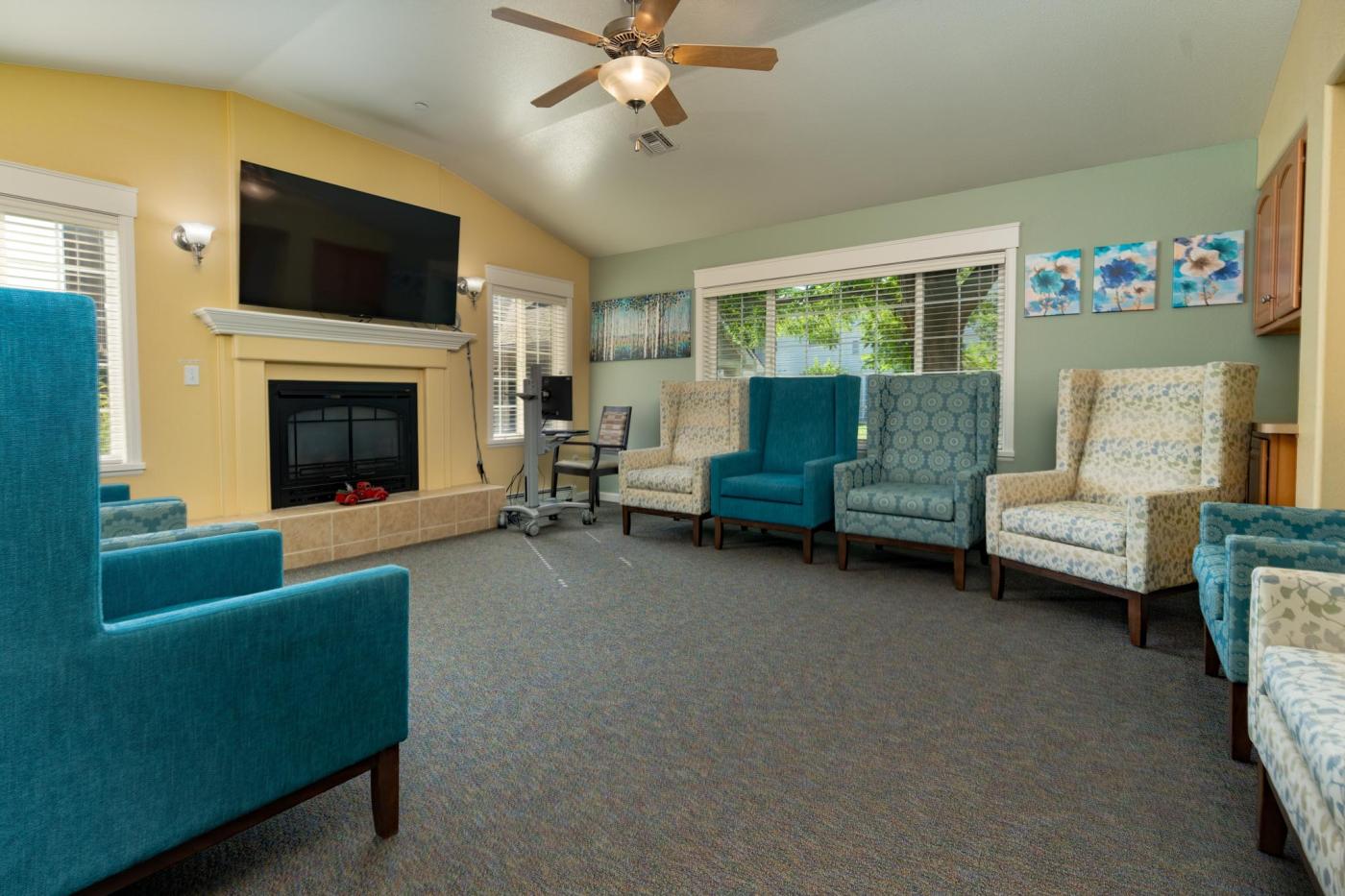 Livingroom with TV & chairs positioned along the walls to see the TV