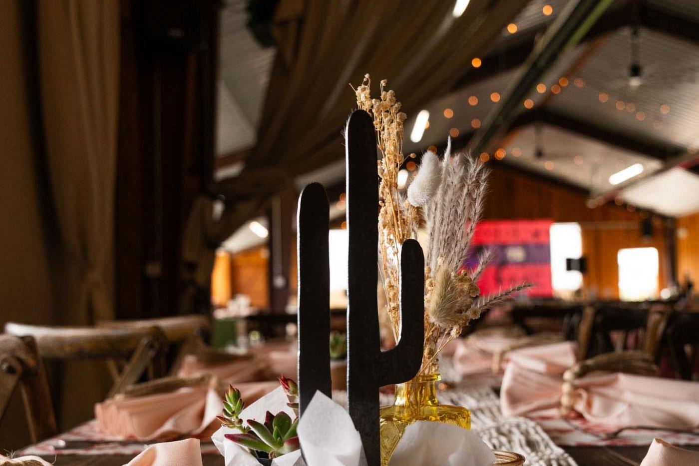 Centerpiece decor with live mini cactus and a metal cactus silhouette
