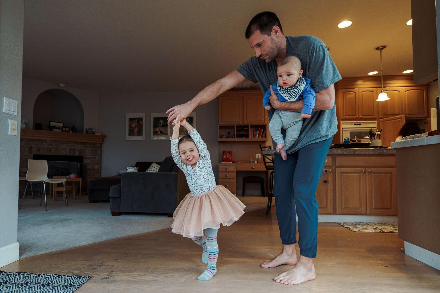 Man dancing with his children