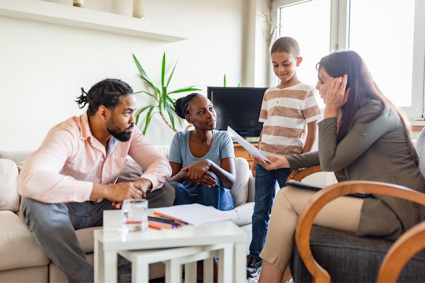 Father, mother, and child in living room with social worker for an in-home visit